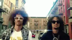 Two men with afros dancing in the street