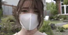 Girl in white mask blinking