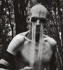 Bald man with long nose in forest