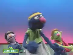 Grover singing with puppets