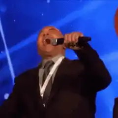 Man singing passionately into microphone