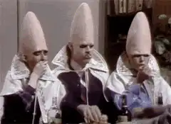 Three Klansmen sitting at a table