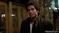 John Travolta walking and smiling