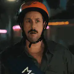 Pedro Pascal in orange helmet looking around