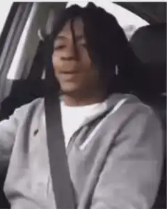 Man in car looks back at baby
