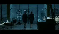 Couple holding hands looking out window