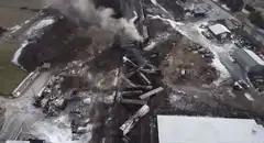 Aerial view of train derailment with smoke
