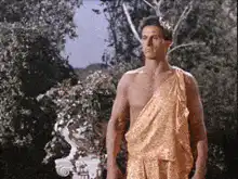Bruce Lee kicks a man in a toga