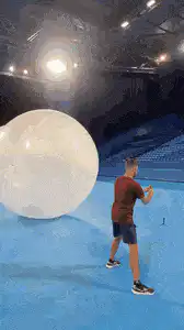 man hits giant ball that explodes