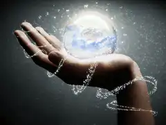Hand holding a glowing earth globe