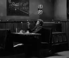 woman smoking in diner booth