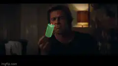 Brad Pitt holds a green candle