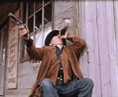 cowboy drinking and holding gun