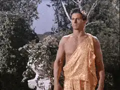 Bruce Lee kicks a guy in a toga