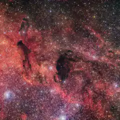 Colorful nebula with dark dust lanes