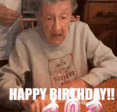 Elderly woman blows out birthday candles
