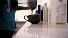 pouring coffee into a mug