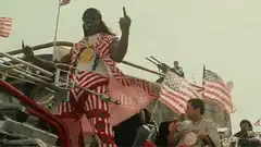 Snoop Dogg in patriotic outfit on vehicle
