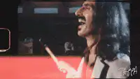 Frank Zappa laughing with drumstick
