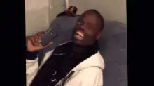 Man laughing hysterically at phone