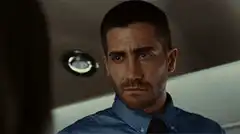 Jake Gyllenhaal smirking and nodding