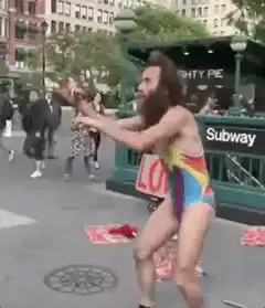 Bearded man in rainbow swimsuit takes selfie with cop