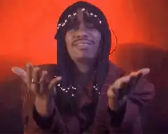Quavo smiling and clapping hands
