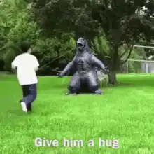 Boy hugs inflatable Godzilla