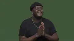 Man in black beanie clapping happily