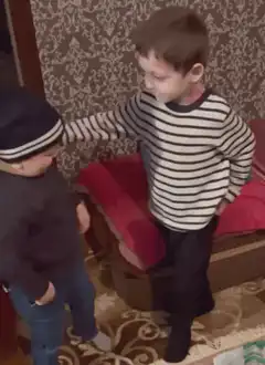 older boy puts arm around younger boy