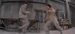 Two men fighting in a workshop