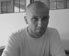 Bald man looking at camera