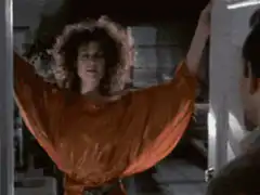 Woman in orange dress spreads arms