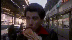 John Travolta eating a hot dog