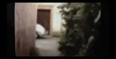 Alien emerges from behind car