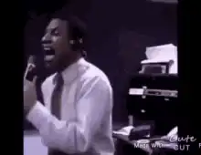 Man singing passionately into microphone