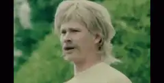 Man with mustache and mullet looking confused