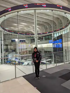 Woman standing in modern glass atrium