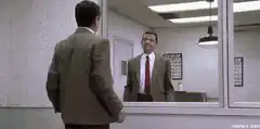 Mr. Bean looks in the mirror