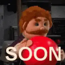 Papa Smurf holding red ball with SOON text