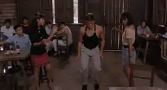 Jean-Claude Van Damme dancing in a bar
