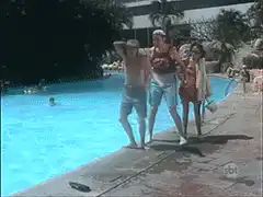 Man jumps into pool while friends watch