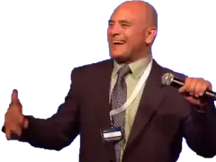 Man in suit laughing with microphone