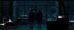 Two people watching city explode