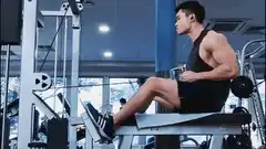 Muscular man doing seated cable row