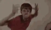 Boy in red shirt dancing