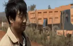 Man looking tired near dump truck