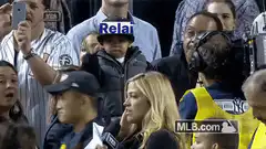 Toddler holding up a sign at a baseball game