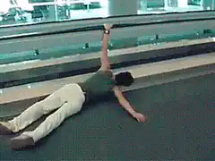 man lying on moving walkway