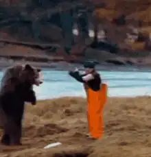 Man in orange pants fights a bear